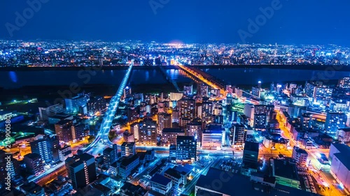 Japan Osaka City Skyline Timelapse. View from Umeda Sky Building. Overlooking the bridges with traffic and train going in and out of the Osaka city center. Zoom in shot.
