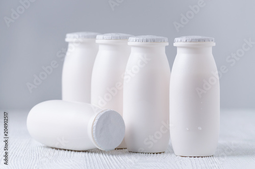 drink yogurt in plastic bottles on gray background