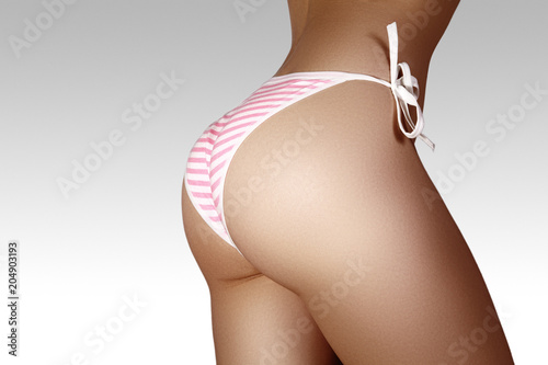 Принти на полотні Close-up view of Female Sport Tanned Buttocks in Sexy Pink Panties