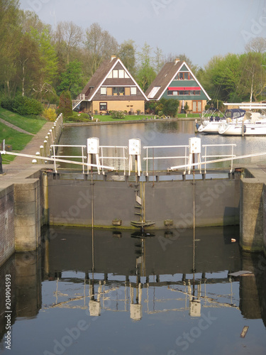 Bild auf Leinwand Canalside houses and closed lock gates
