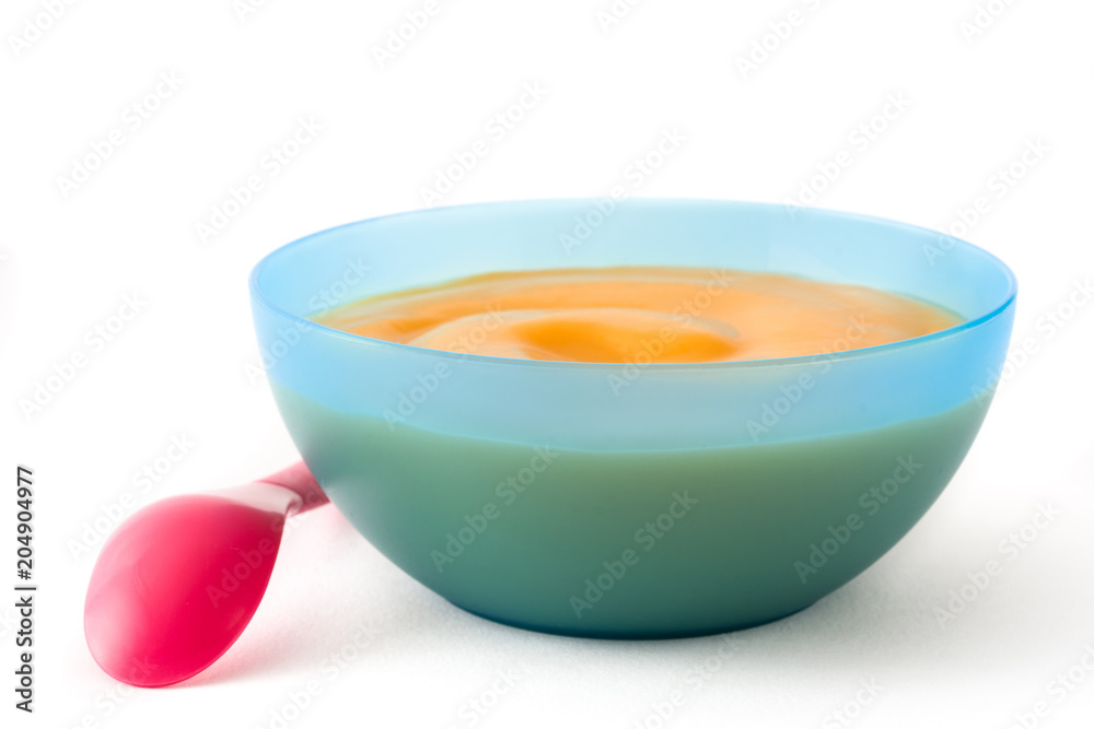 Baby food: blue bowl with fruit puree isolated on white background Baby food: blue bowl with fruit puree isolated on white background