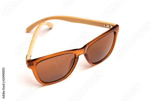 Stylish brown sunglasses with wooden frame isolated on white background