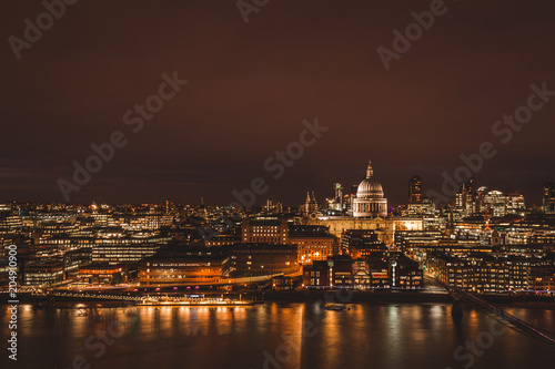 London aerial view of modern city skyline at night on River Thames
