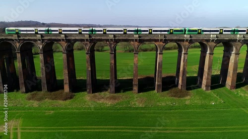 Static drone shot as train crosses the Ouse Valley Viaduct photo