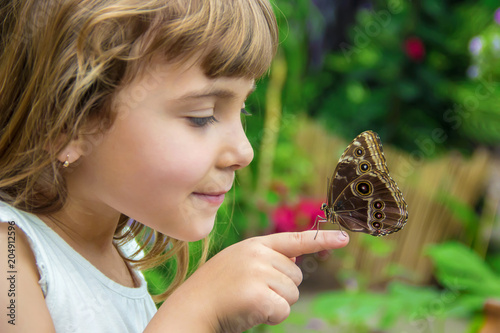 Canvas Print Child with a butterfly. Selective focus.