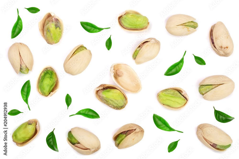 Pistachios decorated with green leaves isolated on white background, top view. Flat lay pattern Pistachios decorated with green leaves isolated on white background, top view. Flat lay pattern
