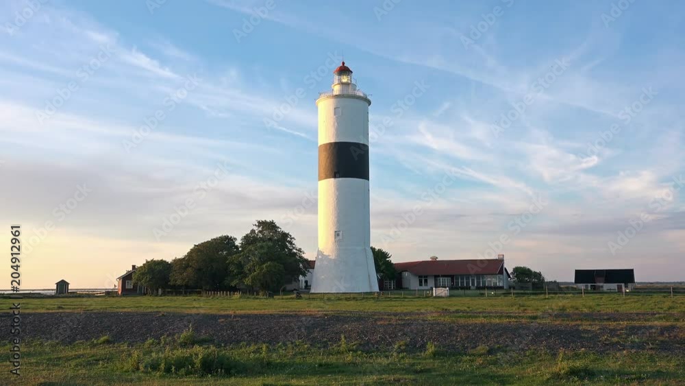 Lighthouse at Sunset on a beautiful landscape with Red Sky. 4K Ultra HD Lighthouse at Sunset on a beautiful landscape with Red Sky. 4K Ultra HD