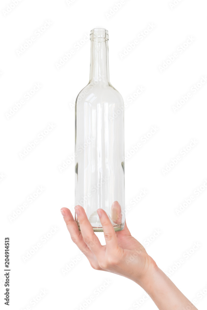Female hand holding empty glass bottle isolated on white. Recyclable waste. Recycling, reuse, garbage disposal, resources, environment and ecology concept Female hand holding empty glass bottle isolated on white. Recyclable waste. Recycling, reuse, garbage disposal, resources, environment and ecology concept