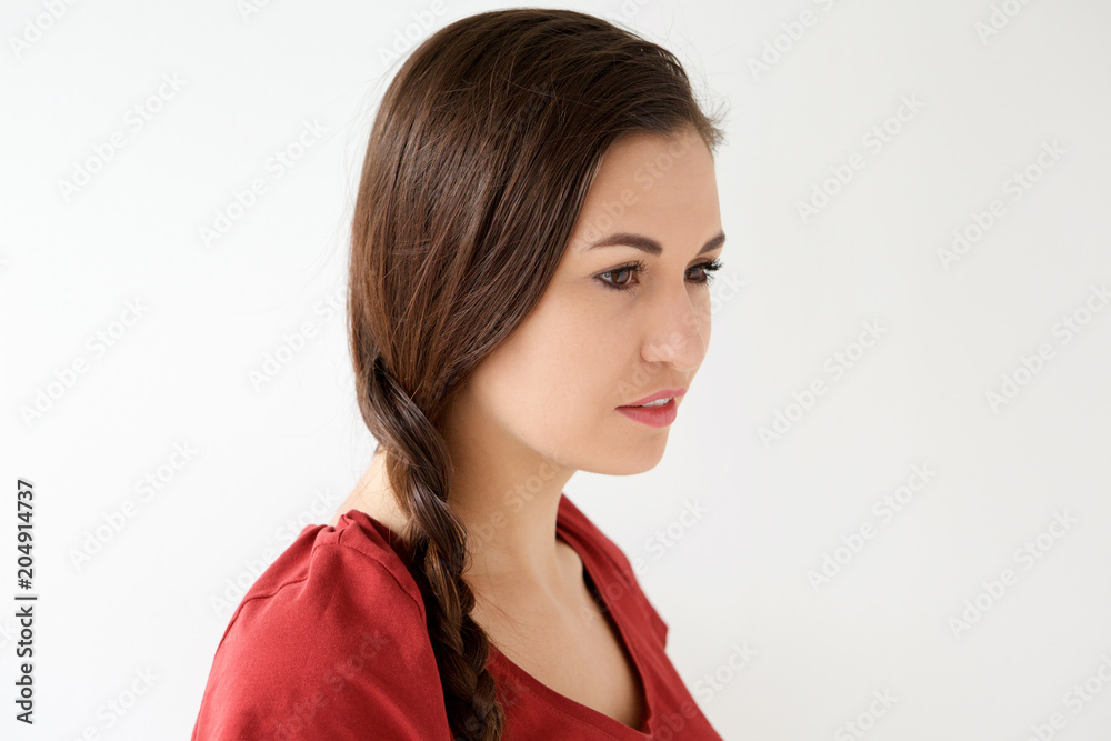 Side of young woman with braided hair against white background Side of young woman with braided hair against white background