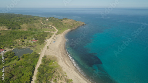 Aerial view of beautiful beach, lagoon and coral reefs. Philippines, Pagudpud. Ocean coastline with turquoise water. Tropical landscape in Asia.