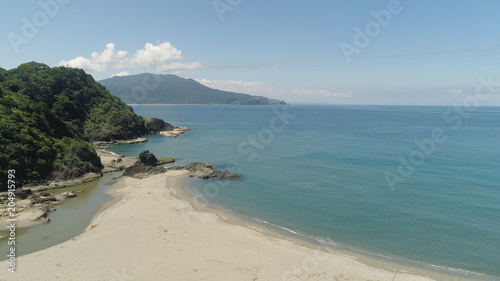 Aerial view of coastline with sandy beautiful beach. Philippines  Luzon. Ocean coastline with turquoise water. Philippines  Luzon. Tropical landscape in Asia.