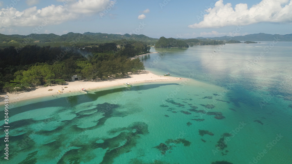 Aerial view of beautiful tropical beach with turquoise water in blue lagoon, Anguib, Philippines, Santa Ana. Ocean coastline with sandy beach, coral reefs. Tropical landscape in Asia.