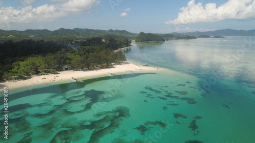 Aerial view of beautiful tropical beach with turquoise water in blue lagoon, Anguib, Philippines, Santa Ana. Ocean coastline with sandy beach, coral reefs. Tropical landscape in Asia.