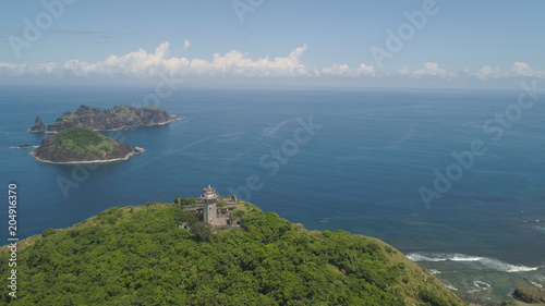 Aerial view of lighthouse in Palau island. Lighthouse in cape Engano against blue sky and rocky islands, province of Cagayan, Philippines. © Alex Traveler
