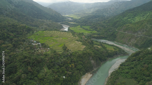 Aerial view of mountain valley in the cordillera, river, rice terraces, farmland in the Philippines, Luzon. Aerial view of mountains covered forest, tree. Cordillera region.