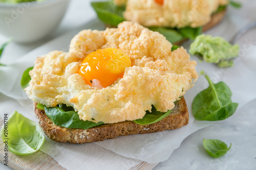 Trendy healthy eating concept - egg clouds on toasts