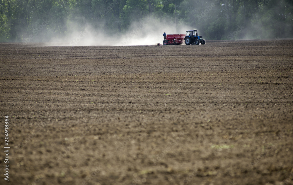 Dust trail behind a tractor in the field. Dust trail behind a tractor in the field.