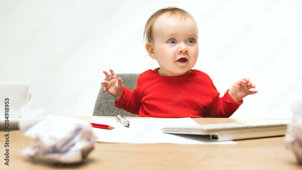 Happy child baby girl toddler sitting with keyboard of computer isolated on a white background Happy child baby girl toddler sitting with keyboard of computer isolated on a white background
