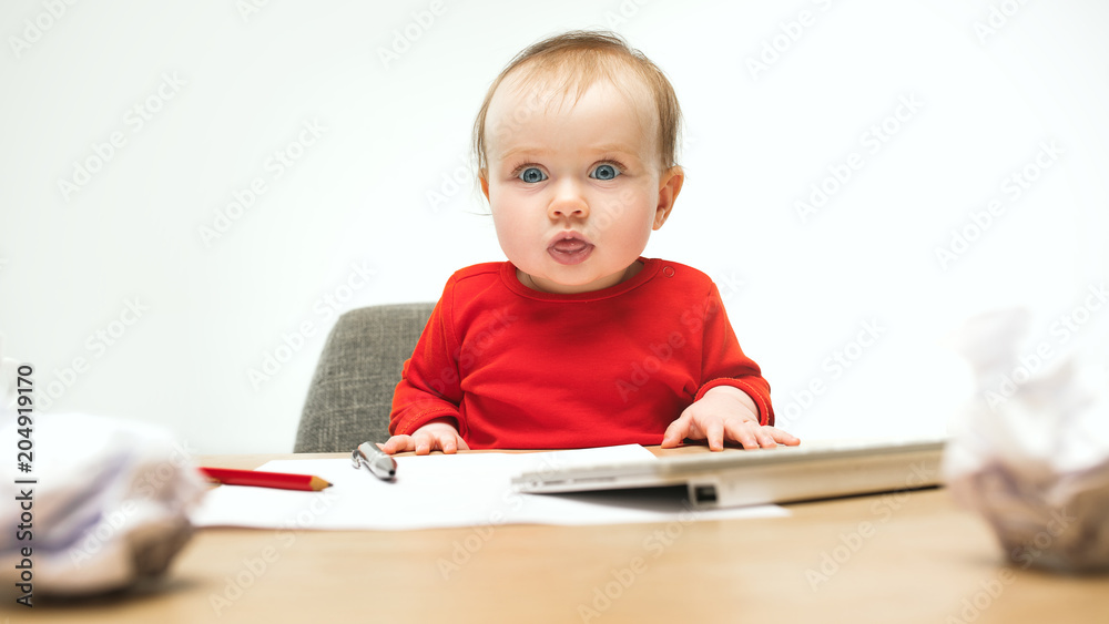 Happy child baby girl toddler sitting with keyboard of computer isolated on a white background Happy child baby girl toddler sitting with keyboard of computer isolated on a white background