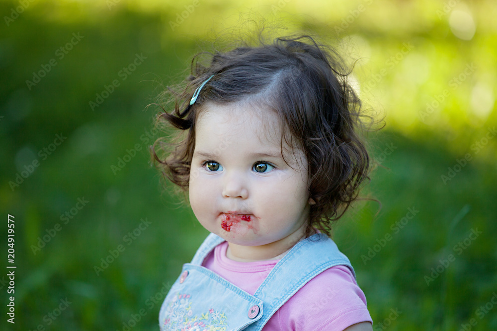 Close up portrait of baby girl eating raspberries Close up portrait of baby girl eating raspberries