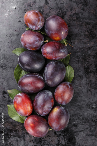 ripe plums on a black background