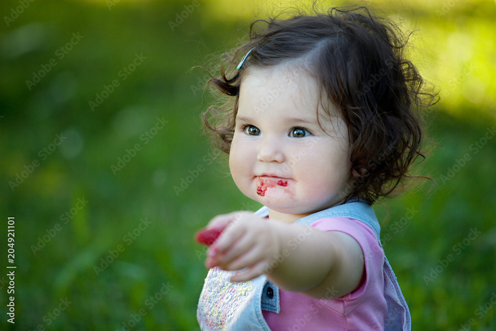 Close up portrait of baby girl eating raspberries Close up portrait of baby girl eating raspberries