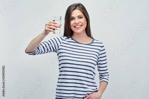 Woman holding water glass. Girl wearing striped shirt.