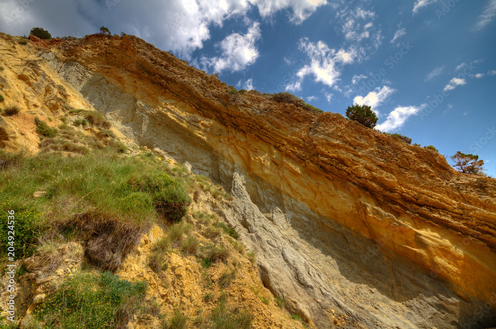Soil profile in a cliff, showing terra rossa, reddish soil, heavy and clay-rich, developed on a limestone base