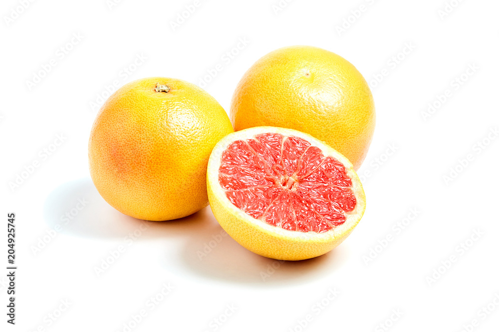 Ripe round grapefruits and red half on white isolated background Ripe round grapefruits and red half on white isolated background