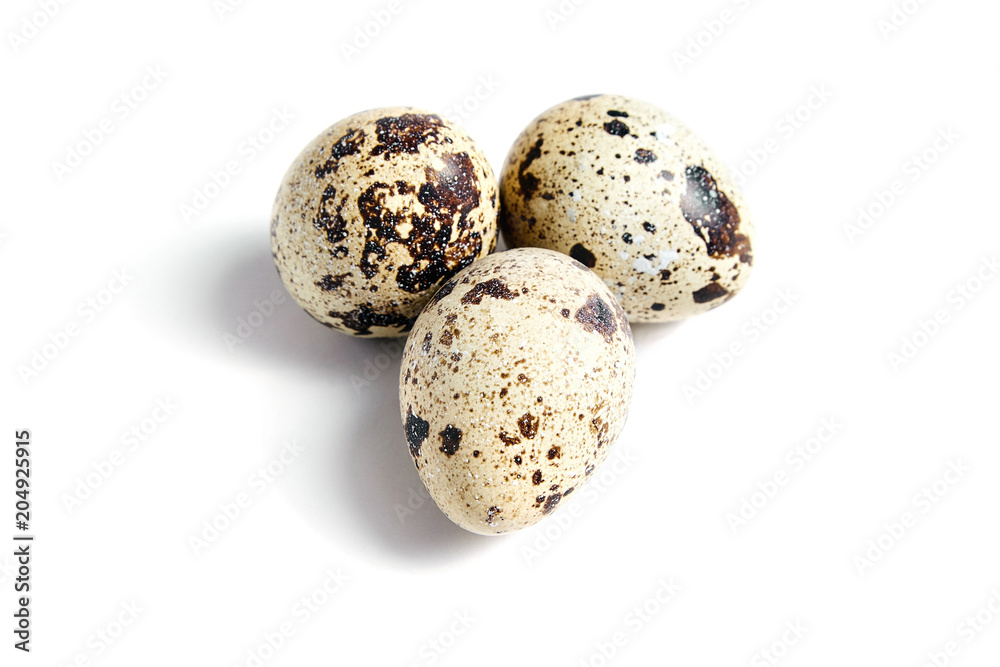 Three Quail spotted eggs, isolated on a white background Three Quail spotted eggs, isolated on a white background