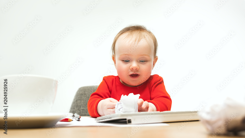 Happy child baby girl toddler sitting with keyboard of computer isolated on a white background Happy child baby girl toddler sitting with keyboard of computer isolated on a white background