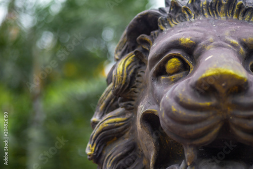 Detail of a famous lion statue on blurred background in thailand