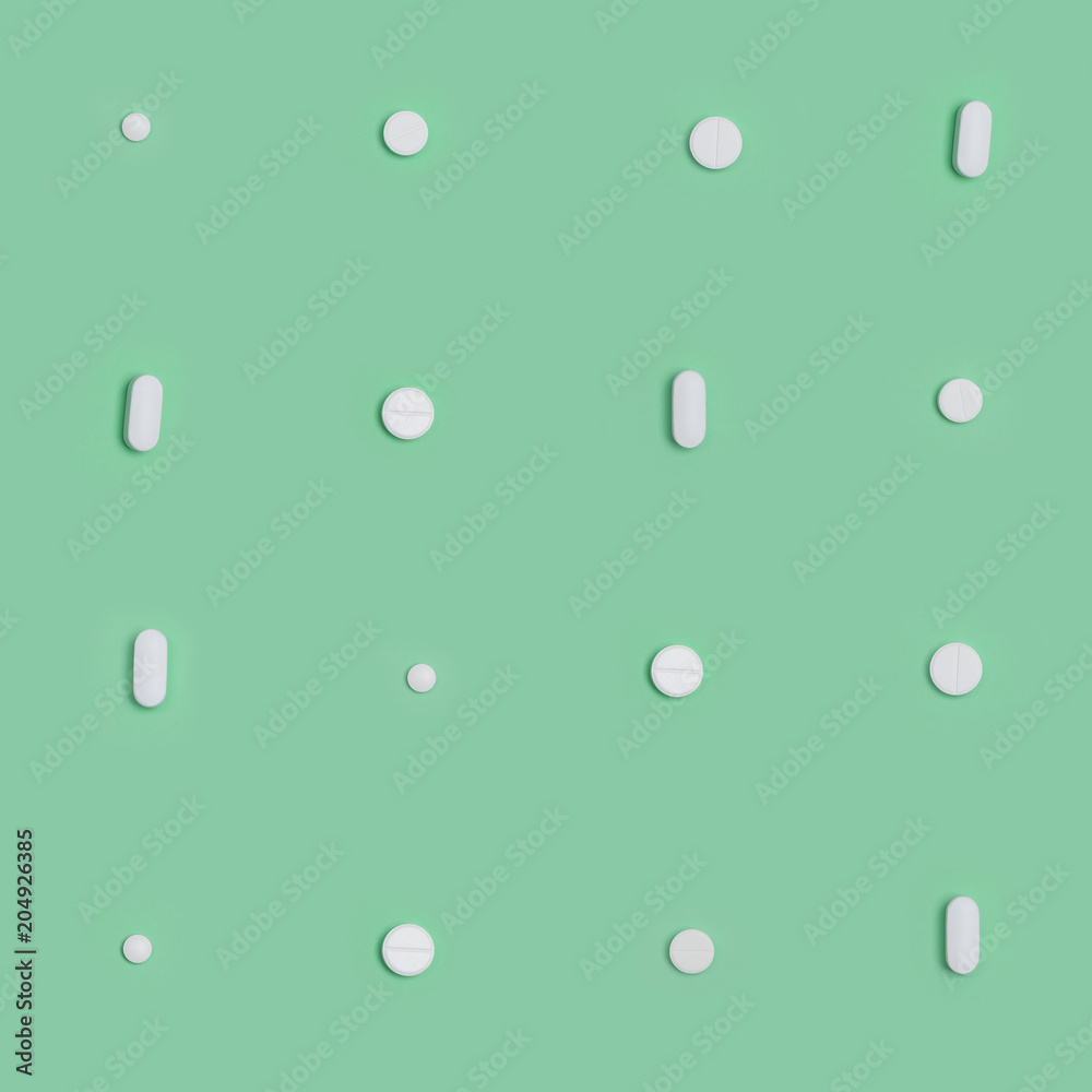 seamless pattern white pills round and oval  on a green background