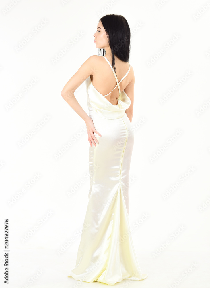 Bride, girl in graceful dress. Fashion model demonstrate expensive fashionable evening dress or wedding dress. Fashion wedding concept. Woman in elegant white dress with nude back, white background. Bride, girl in graceful dress. Fashion model demonstrate expensive fashionable evening dress or wedding dress. Fashion wedding concept. Woman in elegant white dress with nude back, white background.