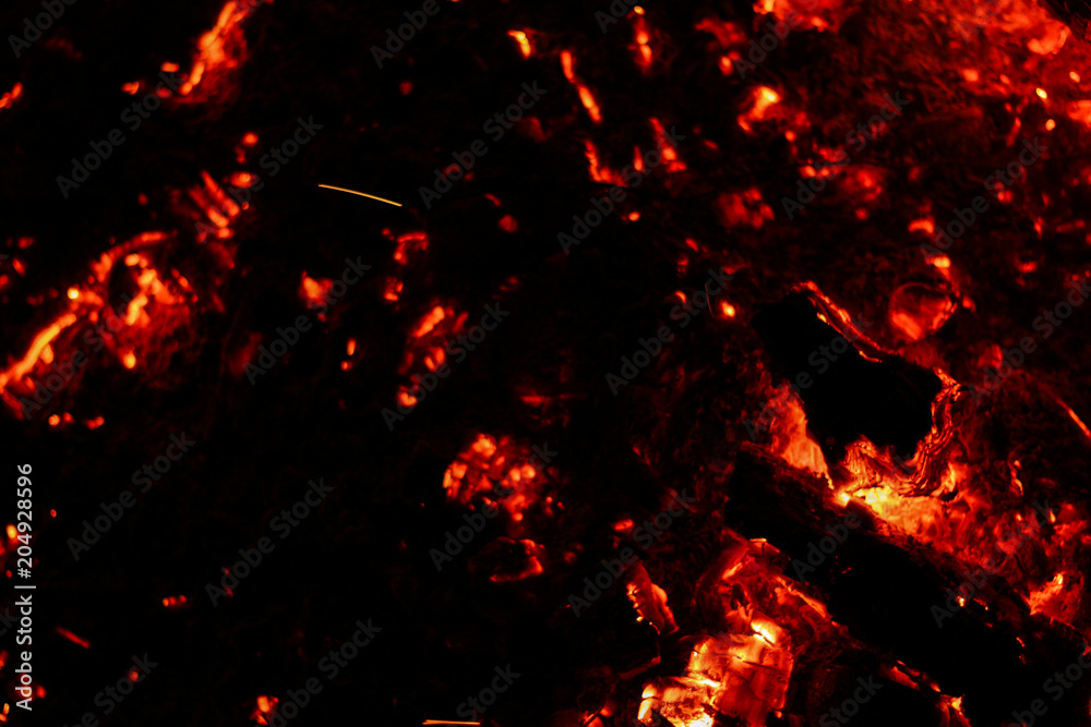 Smoldering coals on a black background