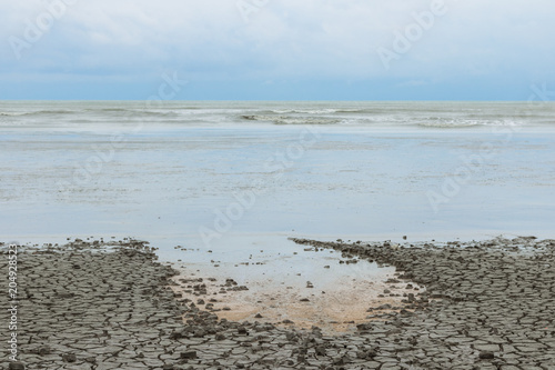 a sea with cracked clay,soil beach