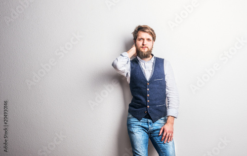 Portrait of a young hipster man in a studio. Copy space.