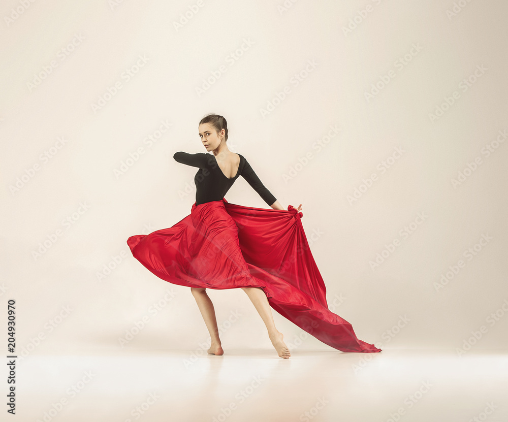 Modern ballet dancer dancing in full body on white studio background.