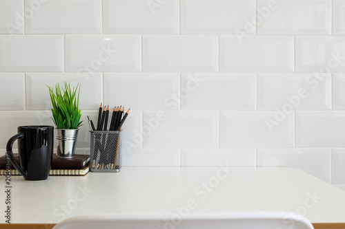 White desk table with copy space, supplies and coffee mug. Front view workspace and copy space