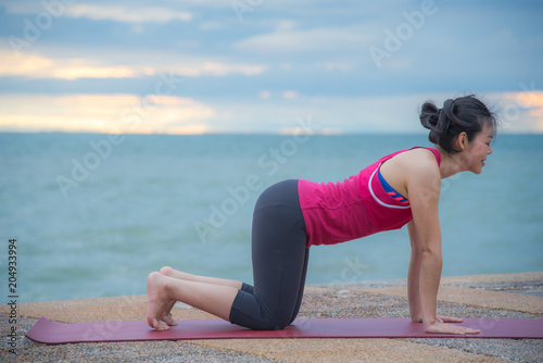 Woman yoga at beach