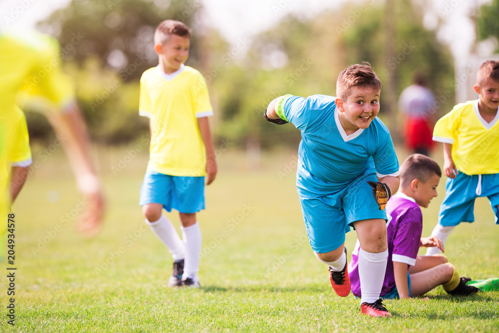 Young children players football match on soccer field Young children players football match on soccer field