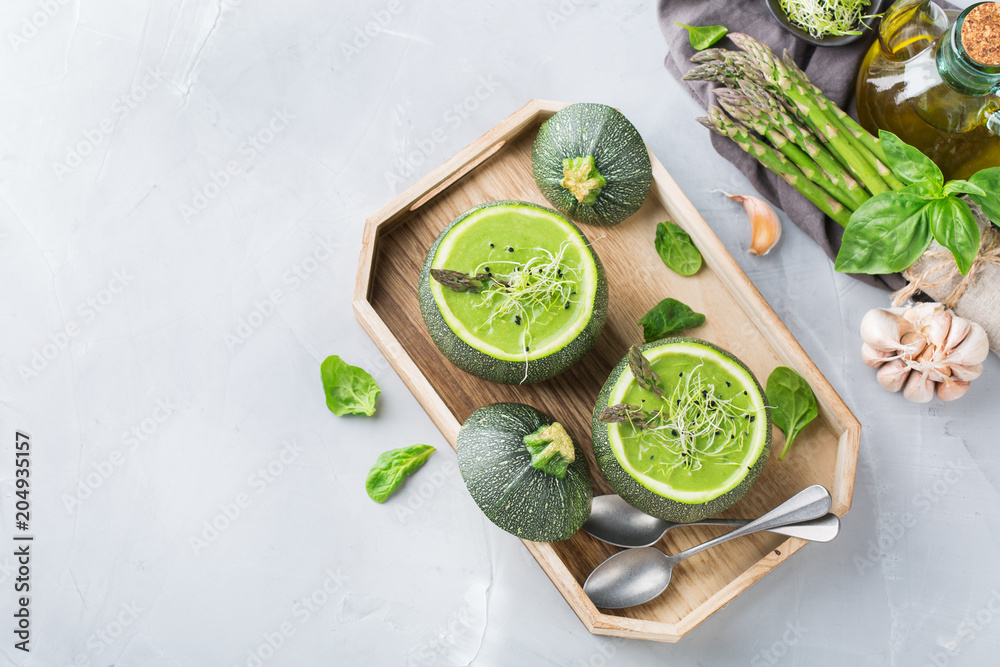 Seasonal creamy asparagus spinach soup served in a round zucchini Seasonal creamy asparagus spinach soup served in a round zucchini
