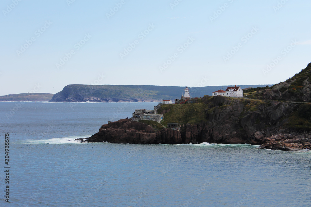 Looking across the ocean from the Signal Hill Trail to Cape Spear, view of Fort Amherst, part of Freshwater Bay, the entrance to Petty Harbour, and the surrounding cliffs. Newfoundland.