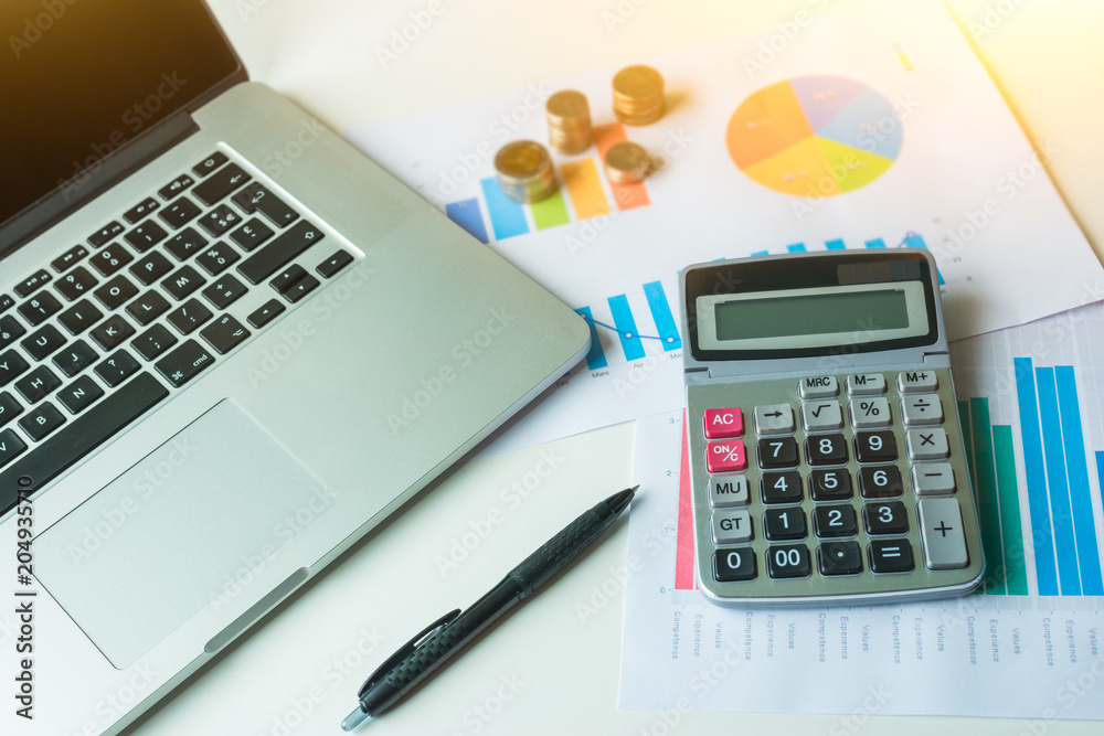 Business financial desk with calculator, laptop and graphic analysis Business financial desk with calculator, laptop and graphic analysis