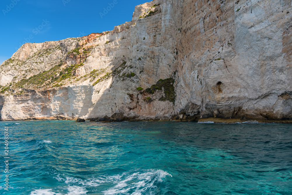 Blue Caves and blue water of Ionian sea on Island Zakynthos in Greece and sightseeing points. Rocks in clear blue sea
