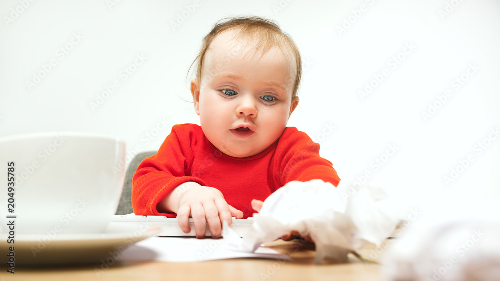 Happy child baby girl toddler sitting with keyboard of computer isolated on a white background Happy child baby girl toddler sitting with keyboard of computer isolated on a white background
