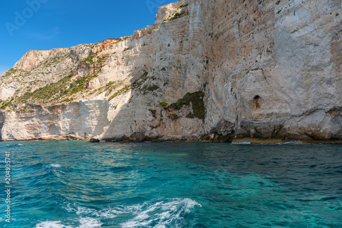 Blue Caves and blue water of Ionian sea on Island Zakynthos in Greece and sightseeing points. Rocks in clear blue sea © djevelekova