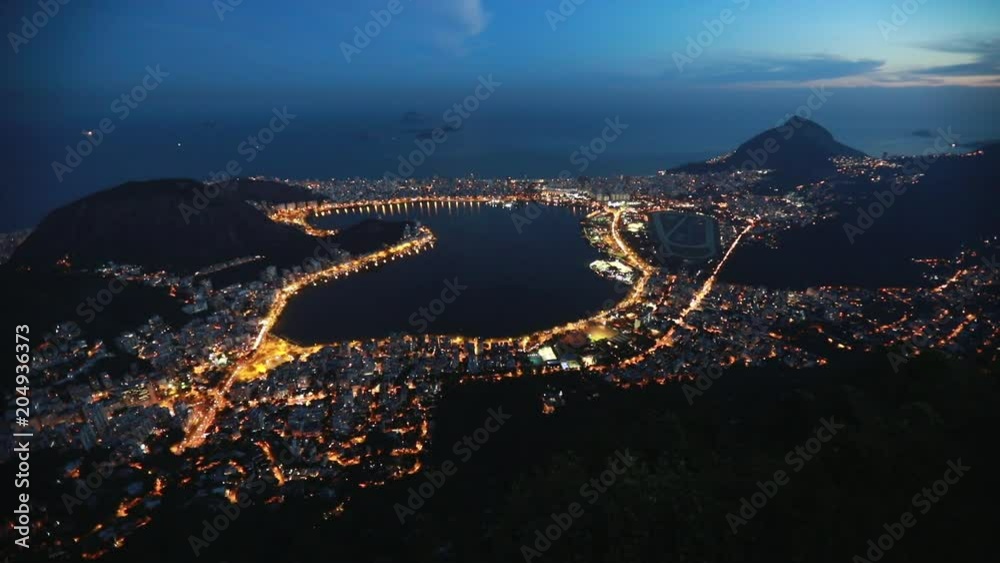 Looking down on the lights of Rio de Janeiro, Brazil from the mountains high above, just after sunset. The lights accent the frenetic nature of Rio, while the mountains accent its natural beauty. Looking down on the lights of Rio de Janeiro, Brazil from the mountains high above, just after sunset. The lights accent the frenetic nature of Rio, while the mountains accent its natural beauty.