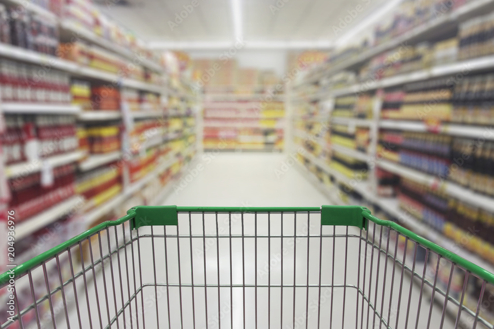 Supermarket aisle with empty shopping cart Supermarket aisle with empty shopping cart