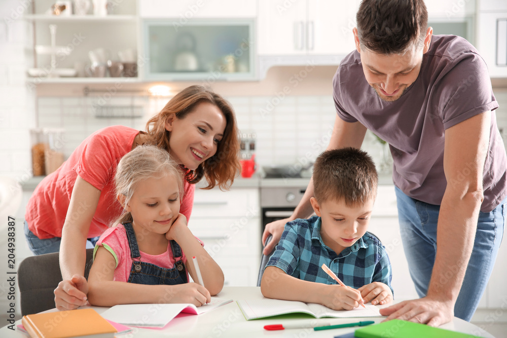 Little children with parents doing homework at home Little children with parents doing homework at home